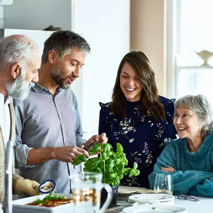 family group talking together in the kitchen space